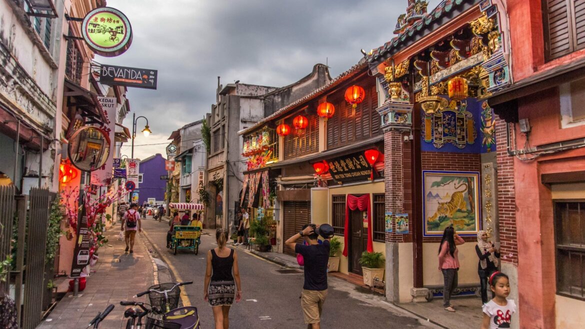 People walking on street in Georgetown, Penang, Malaysia, included in tours offered by Asia Vacation Group