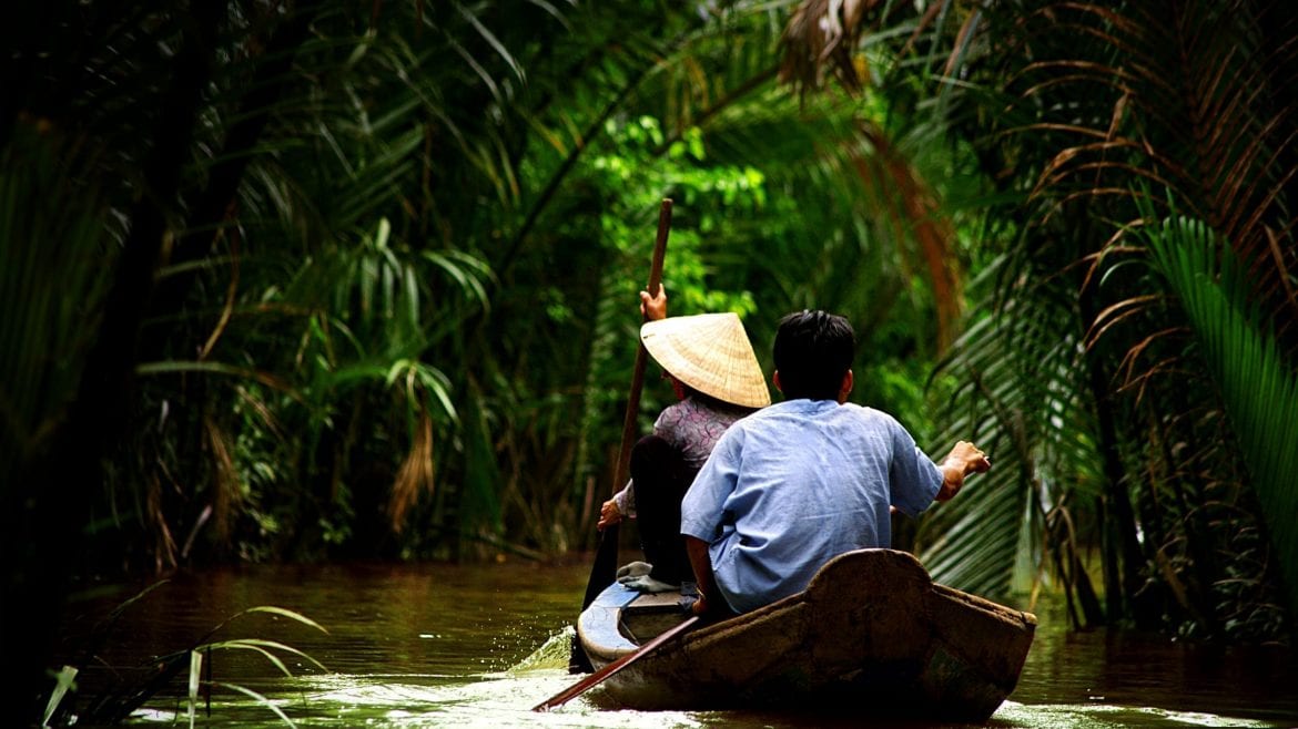 People paddling on Mekong River in Vietnam, included in tours offered by Asia Vacation Group