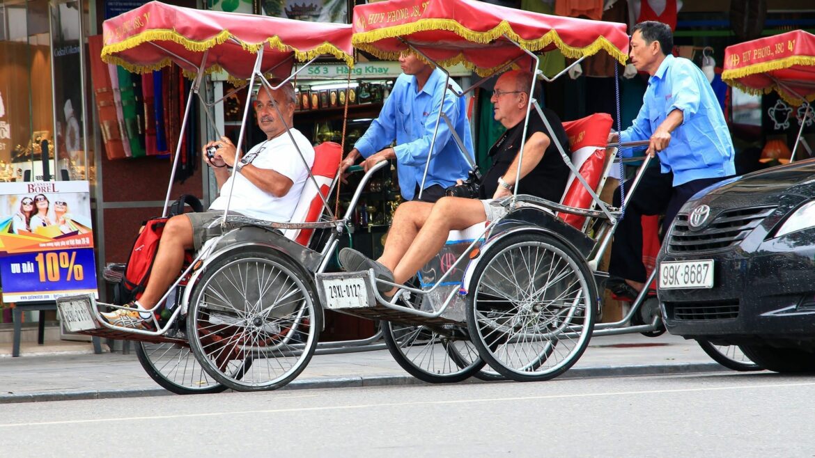 Tourists on Cyclo in Hanoi, Vietnam, included in tours offered by Asia Vacation Group