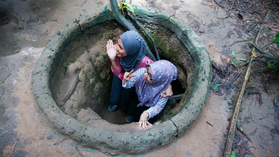 two-girls-sneaking-in-cu-chi-tunnels-saigon-vietnam
